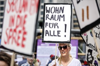 Woman holding a poster with the inscription Wohnraum fuer alle! Demo under the motto The rent is