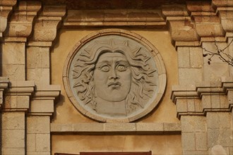 Sun god Helios, A relief of a sun face carved in stone on a historic building, Old Town of Rhodes,