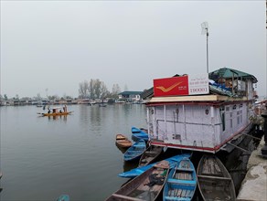 Floating post office in Srinagar, kashmir Docked houseboats and wooden boats on calm water under an