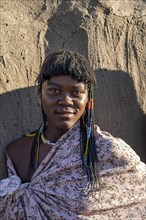 Young traditional Hakaona woman with colourful necklaces, portrait, in the morning light, Angolan