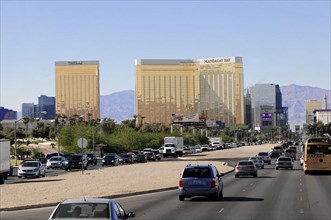 Las Vegas, Nevada, USA, North America, A busy street with cars and tall, gold-coloured buildings in