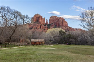 Cathedral Rock sandstone formations tower over a rustic barn at the Crescent Moon Picnic Site in