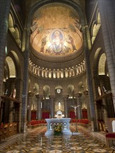 Sacred church interior with mosaic, arches and festively decorated altar, Monte Carlo, Monaco,