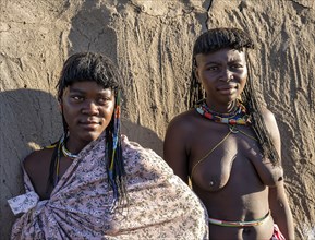 Two young traditional Hakaona woman with colourful necklaces, portrait, in the morning light,