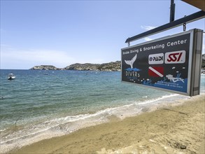 Sign of diving centre base diving school for recreational divers on beach of holiday resort Agia