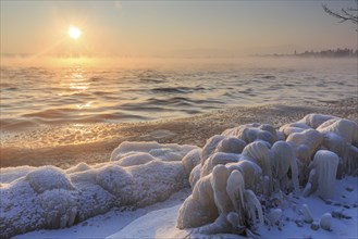 Shore of a lake covered with ice at sunrise, winter, Lake Starnberg, Alpine foothills, Upper