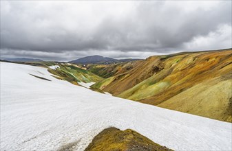 Colourful volcanic landscape with hills and snow, Laugavegur trekking trail, Landmannalaugar,