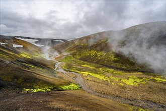 Colourful volcanic landscape with hills and snow, volcanic steaming hot springs, Laugavegur