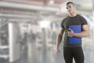 Personal Trainer, with a pad in his hand