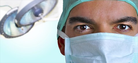 Closeup portrait of a surgeon with a operating room behind
