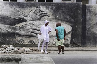 Havana, Cuba, Central America, Cubans in front of a large graffiti, Central America