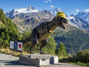 Dinosaur sculpture a barrage de Emosson in front of snow covered mountains, Valais, Switzerland,