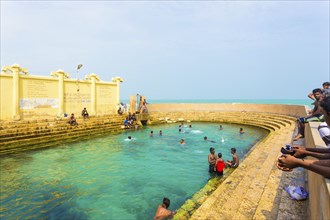 Keerimalai, Sri Lanka, February 5, 2015: Sri Lankan swimmers enjoy the Keerimalai Hot Springs, a