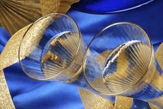 Close-up of two glasses of italian spumante over a blue background. Selective focus