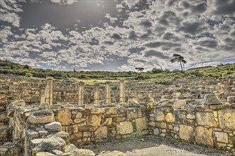 HDR, Super wide angle shot, Ancient ruins with stone walls under a dramatic cloudy sky, Atrium