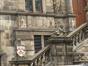 Ornate historic building with statues and coats of arms on an impressive stone staircase, Leiden,
