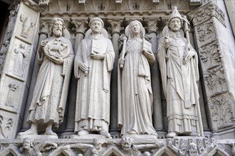 Figures of saints, Detail of the Gothic entrance portal of Notre Dame de Paris Cathedral, Paris,