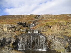 Autumn landscape with waterfall at Isafjordur in the northwest of Iceland