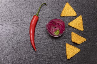 Onion salsa with chips on slate