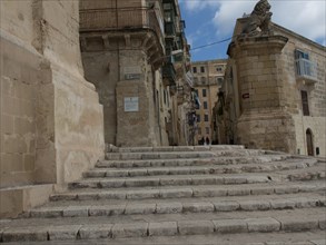 Guided tour of the old town centre through stone steps and impressive stone buildings under a