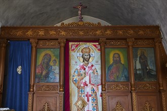 Interior with richly decorated iconostasis and religious images of saints, Kastro Monolithou,