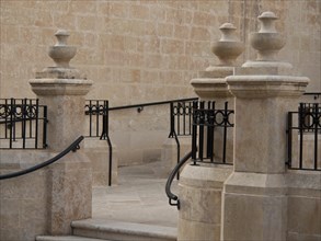Close-up of a stone staircase with wrought-iron railing and wall, valetta, mediterranean sea, malta