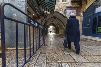 Historic street in the old town of Jerusalem with Police barrier