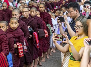 AMARAPURA, MYANMAR, JANUARY 12, 2018: Monks who live in the Mahagandayon monastery come out to