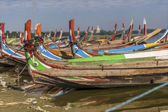 Colourful boats in front of the U Bein bridge