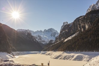 Sun over the winter landscape of Gosausee with the Dachstein in the background