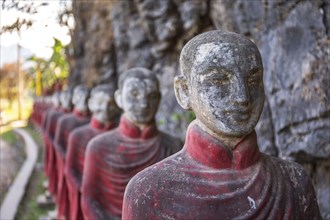 Long row of monk statues at Kaw Ka Thaung cave