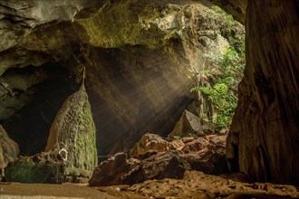 Sunrays illuminating sacred rock in the Kaw Goon cave