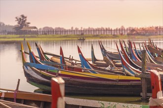 Wooden boats in Ubein Bridge at sunrise, Mandalay, Myanmar (World longest wooden bridge)