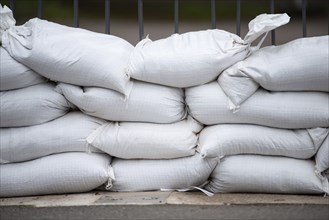 Sandbags for flood defense, river Moselle Trier in Rhineland Palatinate, flooded trees and paths,