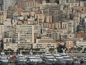 Harbour view with numerous yachts in front of densely packed high-rise buildings, monte carlo,