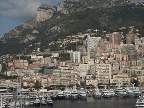 Coast with marina and many buildings, nestled in a mountainous landscape, monte carlo, monaco,