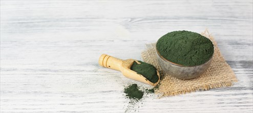 Spirulina algae powder in a bowl, alternative medicine for to detox, antioxidant food ingredients