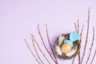 Easter bunny or rabbit in a bird nest, made from an egg and crocheted ears, spring holiday,