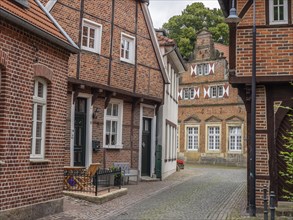 Historic village street with half-timbered houses and brick buildings, Legden, münsterland,