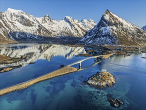 Aerial view of bridge, fjord, steep mountains, coast, winter, evening light, reflection,