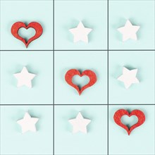 Tic tac toe game with red hearts and stars, symbol for love and emotion, valentines day