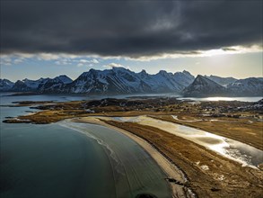 Aerial view of beach and mountains, coast, winter, sun, backlight, Moskenesoya, Lofoten, Norway,