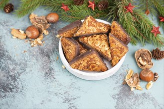 Nut corner triangles, traditional german sweets called Nussecke, covered with chocolate, christmas