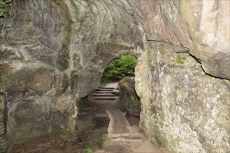 Huel Lee or Hohllay on the Mullerthal trail in Luxembourg, open cave with view to the forest,