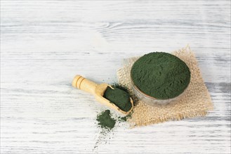 Spirulina algae powder in a bowl, alternative medicine for to detox, antioxidant food ingredients