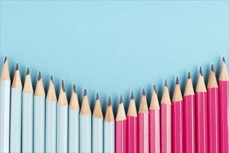 Blue and pink colored pencils building a row, copy space for text, back to school, education
