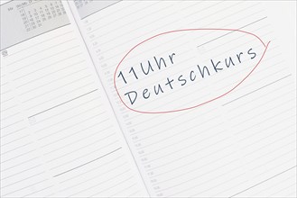 The words german course at 11 oÂ´clock are standing in the german language in the calendar,