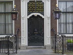 A detailed entrance with ornate doors and lanterns in a historic city building, Delft, Holland,