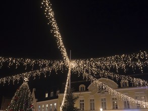 Fairy lights stretching across a square and festively illuminating a building, Ahaus, Münsterland,