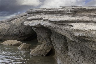 Rock formation showing wind and water erosion along the rocky coast of Boltodden in summer,